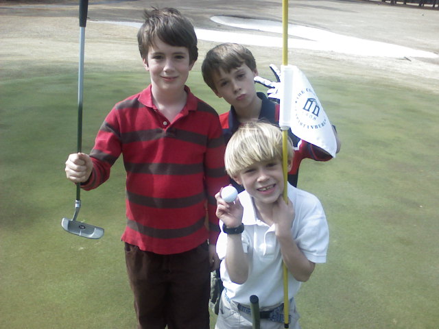 three junior golfers